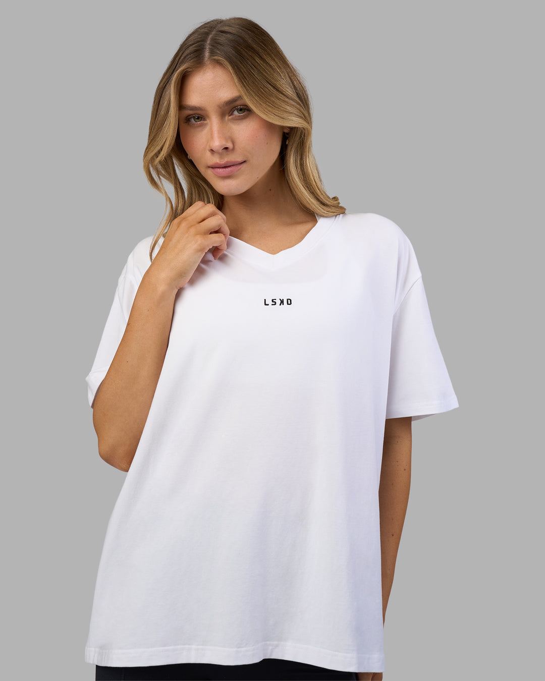 Woman wearing Go-To V-Neck FLXCotton Oversized Tee - White-Black | Model:Leilani | Size:XS - view 1