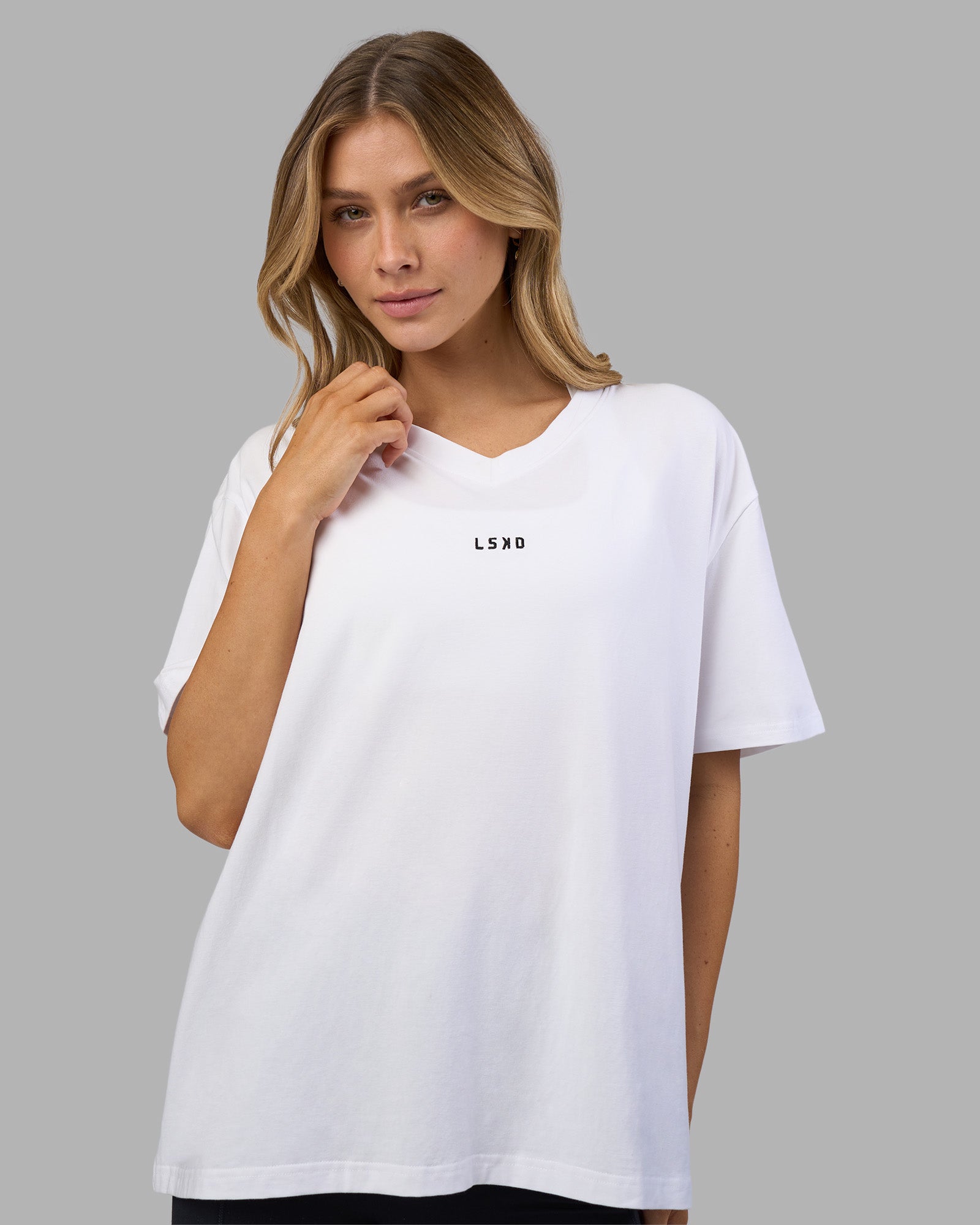 Woman wearing Go-To V-Neck FLXCotton Oversized Tee - White-Black | Model:Leilani | Size:XS