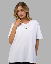 Woman wearing Go-To V-Neck FLXCotton Oversized Tee - White-Black | Model:Leilani | Size:XS | Thumbnail Index: 0