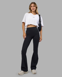 Woman wearing Go-To V-Neck FLXCotton Oversized Tee - White-Black | Model:Leilani | Size:XS | Thumbnail Index: 1