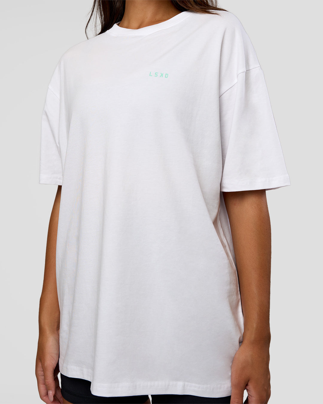 Woman wearing High Run FLXCotton Oversized Tee - White-Jelly Mint | Model:Kirstyn | Size:XS - view 9