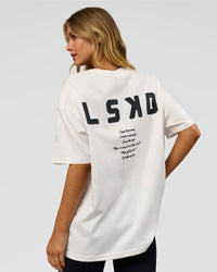 Woman wearing Hype Heavyweight Unisex Oversized Tee - Off White-Black | Model:Leilani | Size:XS | Thumbnail Index: 15