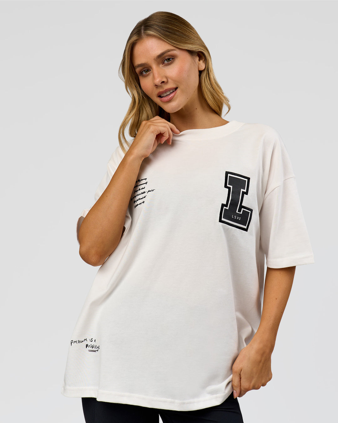Woman wearing Hype Heavyweight Unisex Oversized Tee - Off White-Black | Model:Leilani | Size:XS - view 17