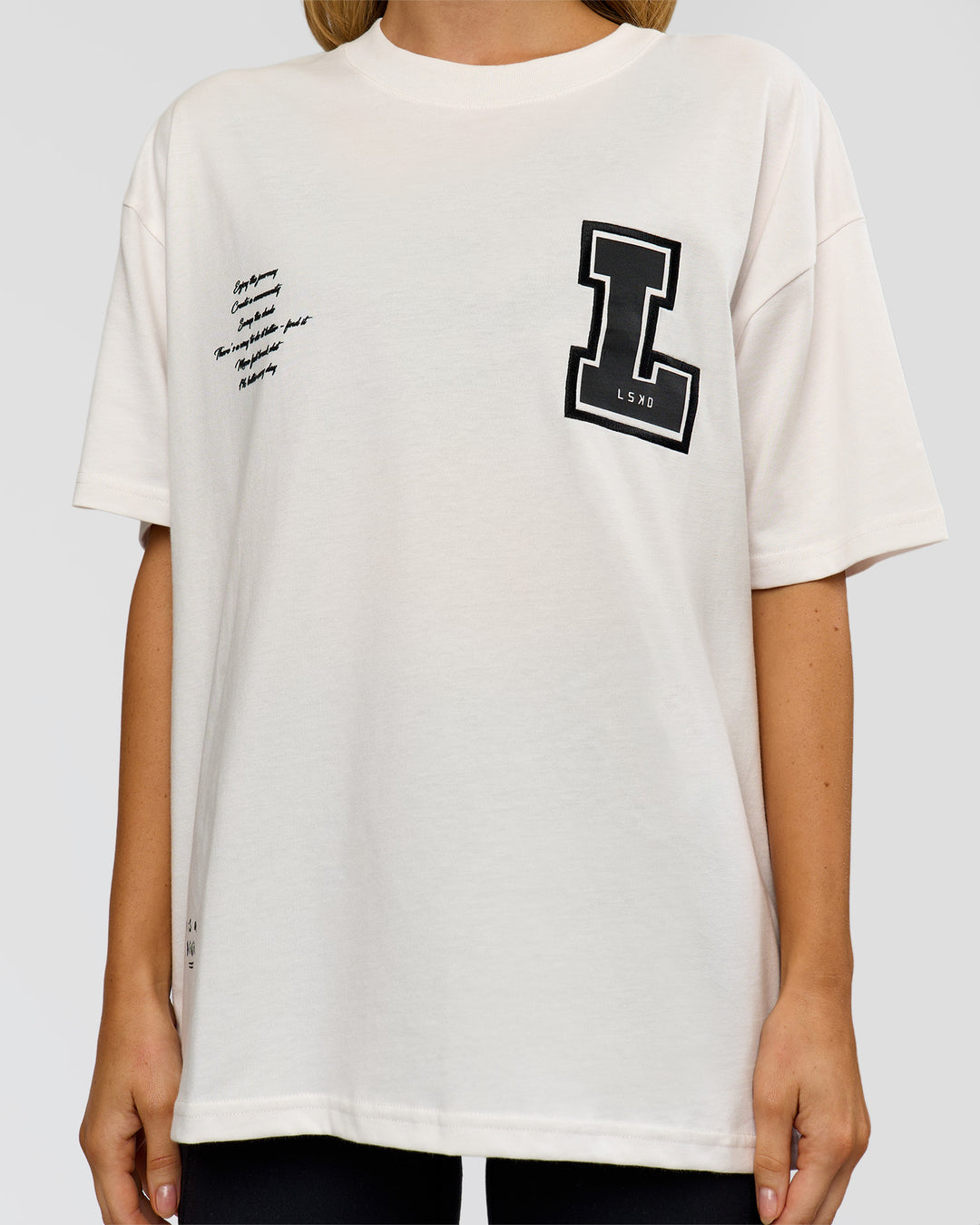 Woman wearing Hype Heavyweight Unisex Oversized Tee - Off White-Black | Model:Leilani | Size:XS - view 20