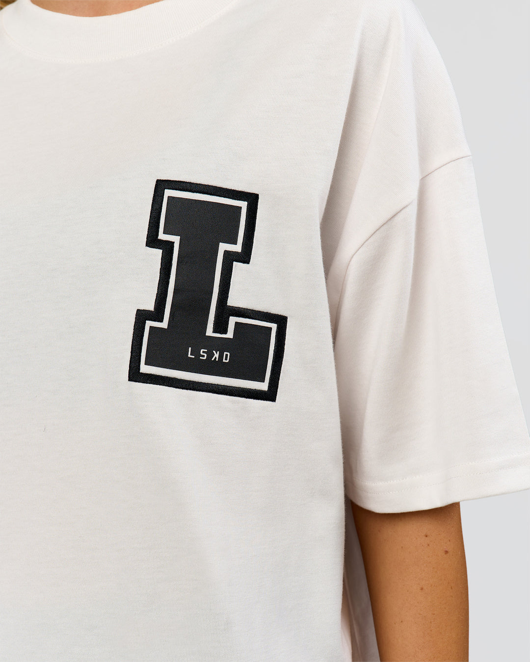 Woman wearing Hype Heavyweight Unisex Oversized Tee - Off White-Black | Model:Leilani | Size:XS - view 21