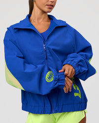 Woman wearing Hype Oversized Track Jacket - Electric Indigo | Model:Brylee | Size:XS | Thumbnail Index: 2