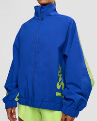 Woman wearing Hype Oversized Track Jacket - Electric Indigo | Model:Brylee | Size:XS | Thumbnail Index: 6