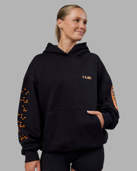 Woman wearing Hyped Unisex Oversized Hoodie - Black-Vibrant Orange | Model:Neve | Size:XS | Thumbnail Index: 2