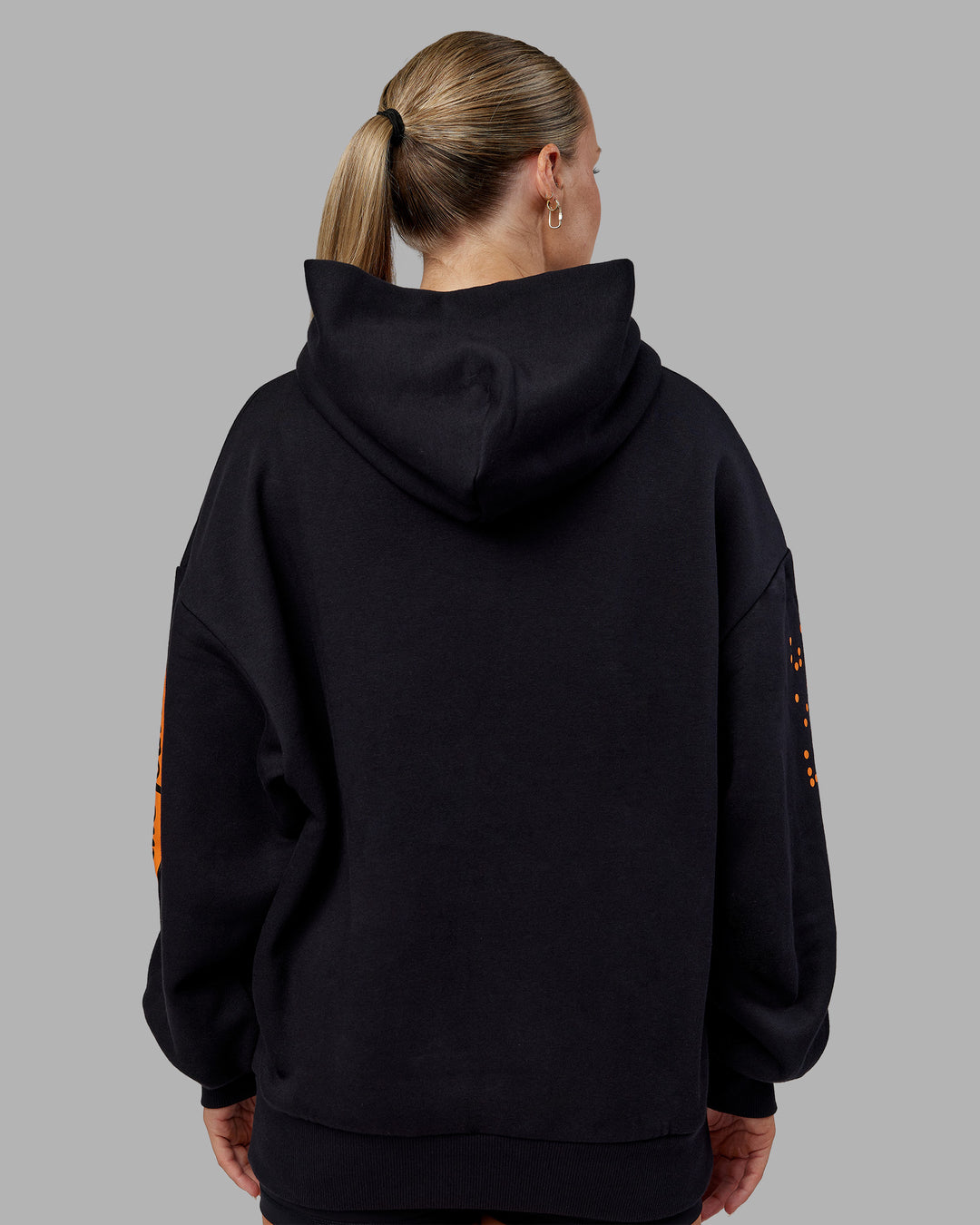 Woman wearing Hyped Unisex Oversized Hoodie - Black-Vibrant Orange | Model:Neve | Size:XS - view 15