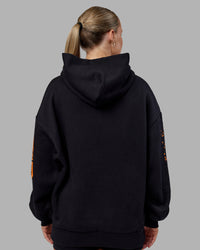 Woman wearing Hyped Unisex Oversized Hoodie - Black-Vibrant Orange | Model:Neve | Size:XS | Thumbnail Index: 14