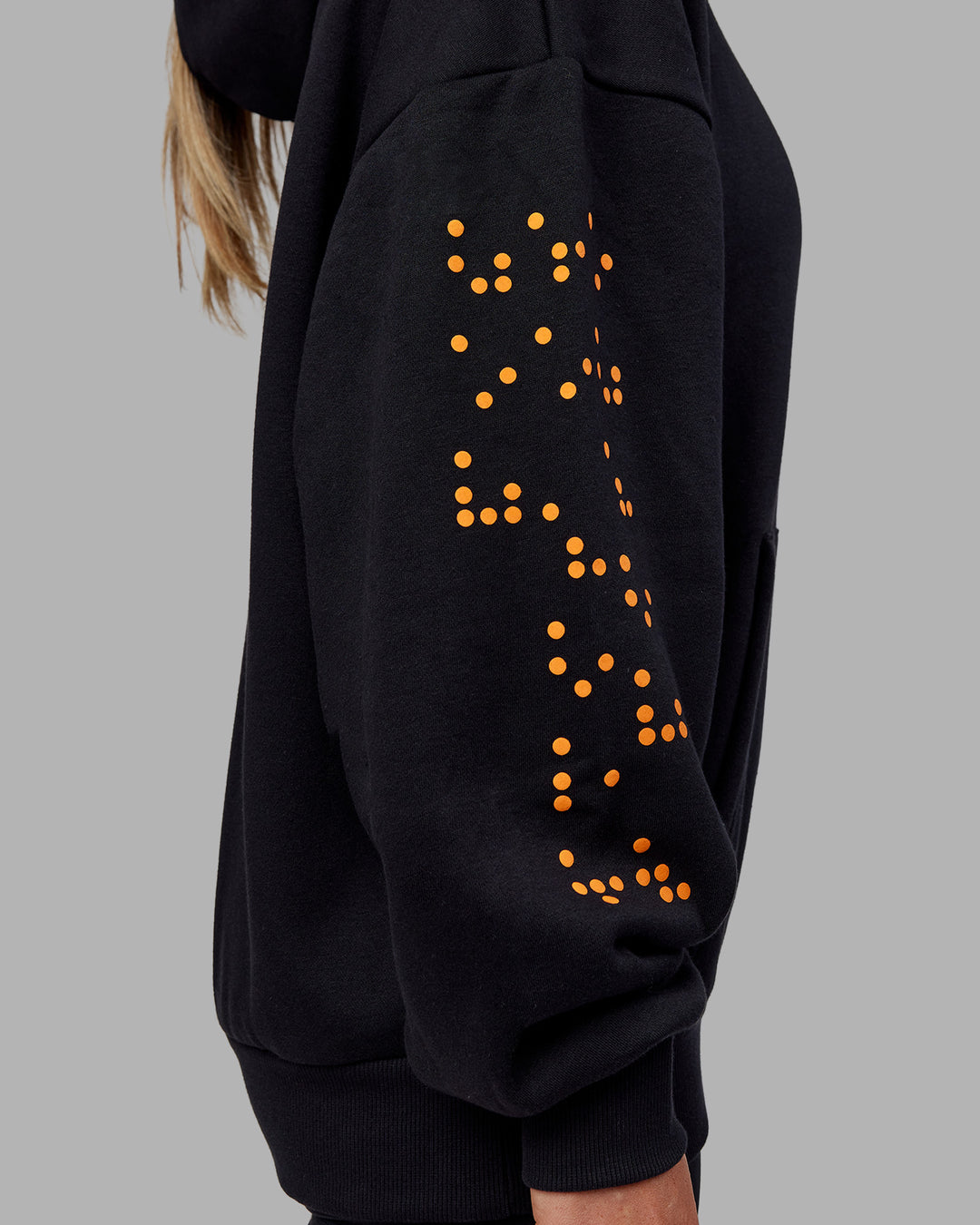 Woman wearing Hyped Unisex Oversized Hoodie - Black-Vibrant Orange | Model:Neve | Size:XS - view 16
