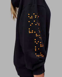 Woman wearing Hyped Unisex Oversized Hoodie - Black-Vibrant Orange | Model:Neve | Size:XS | Thumbnail Index: 15