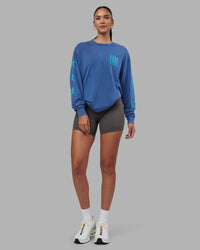 Woman wearing Inferno Journey FLXCotton Oversized Long Sleeve Tee - Midnight Blue-Blue Bird | Model:Rhiley | Size:XS | Thumbnail Index: 11