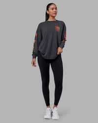 Woman wearing Inferno Journey FLXCotton Oversized Long Sleeve Tee - Washed Black-Ultra Orange | Model:Rhiley | Size:XS | Thumbnail Index: 13