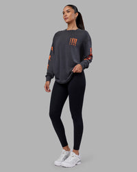 Woman wearing Inferno Journey FLXCotton Oversized Long Sleeve Tee - Washed Black-Ultra Orange | Model:Rhiley | Size:XS | Thumbnail Index: 8
