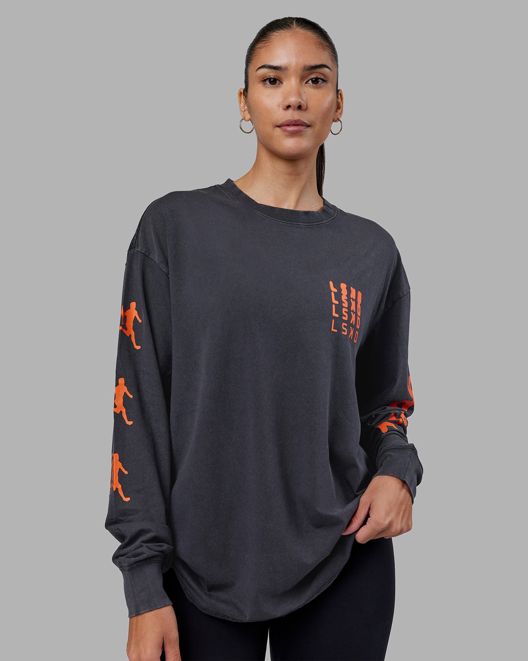 Woman wearing Inferno Journey FLXCotton Oversized Long Sleeve Tee - Washed Black-Ultra Orange | Model:Rhiley | Size:XS - view 5