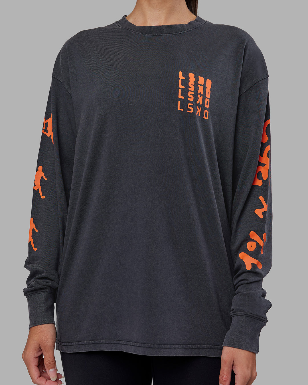Woman wearing Inferno Journey FLXCotton Oversized Long Sleeve Tee - Washed Black-Ultra Orange | Model:Rhiley | Size:XS - view 11