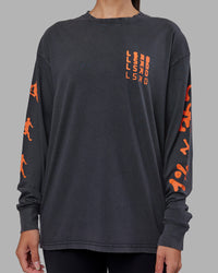 Woman wearing Inferno Journey FLXCotton Oversized Long Sleeve Tee - Washed Black-Ultra Orange | Model:Rhiley | Size:XS | Thumbnail Index: 10