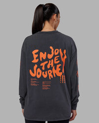 Woman wearing Inferno Journey FLXCotton Oversized Long Sleeve Tee - Washed Black-Ultra Orange | Model:Rhiley | Size:XS | Thumbnail Index: 9