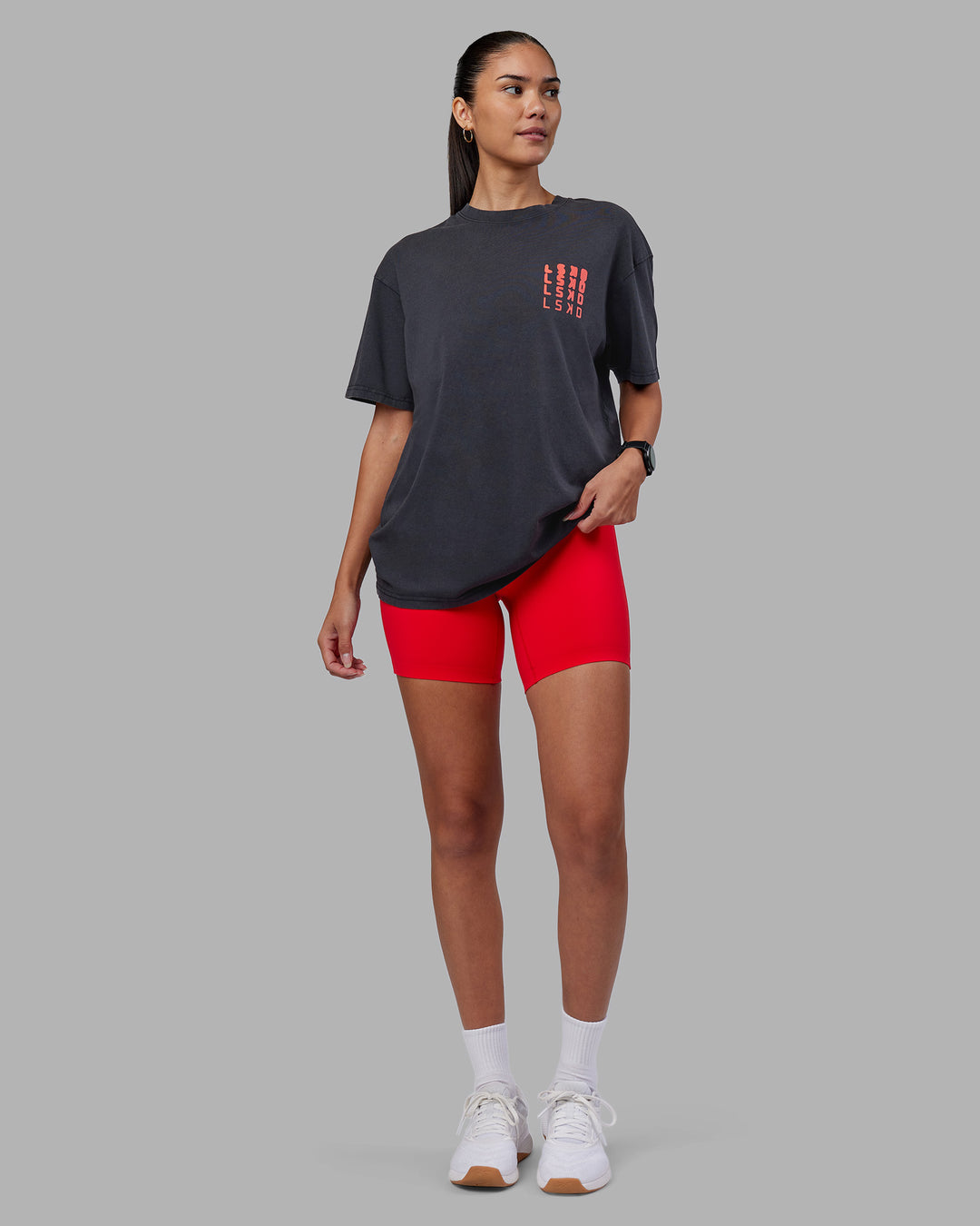 Woman wearing Inferno Journey FLXCotton Oversized Tee - Black Washed-Ultra Orange | Model:Rhiley | Size:XS - view 12