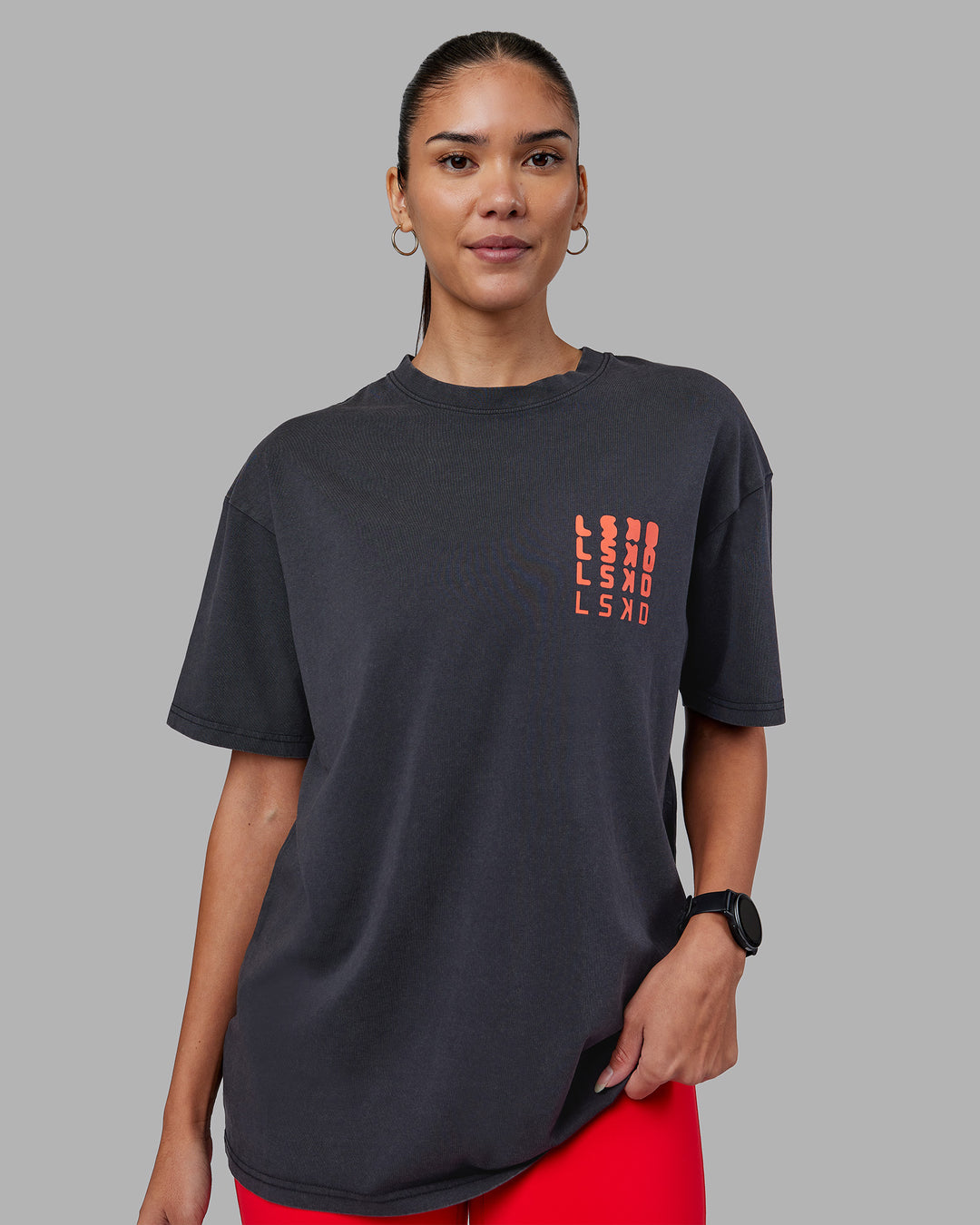 Woman wearing Inferno Journey FLXCotton Oversized Tee - Black Washed-Ultra Orange | Model:Rhiley | Size:XS - view 3