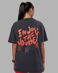 Woman wearing Inferno Journey FLXCotton Oversized Tee - Black Washed-Ultra Orange | Model:Rhiley | Size:XS | Thumbnail Index: 4