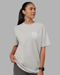 Woman wearing Inferno Journey FLXCotton Oversized Tee - Digital Mist Washed-White | Model:Rhiley | Size:XS | Thumbnail Index: 1