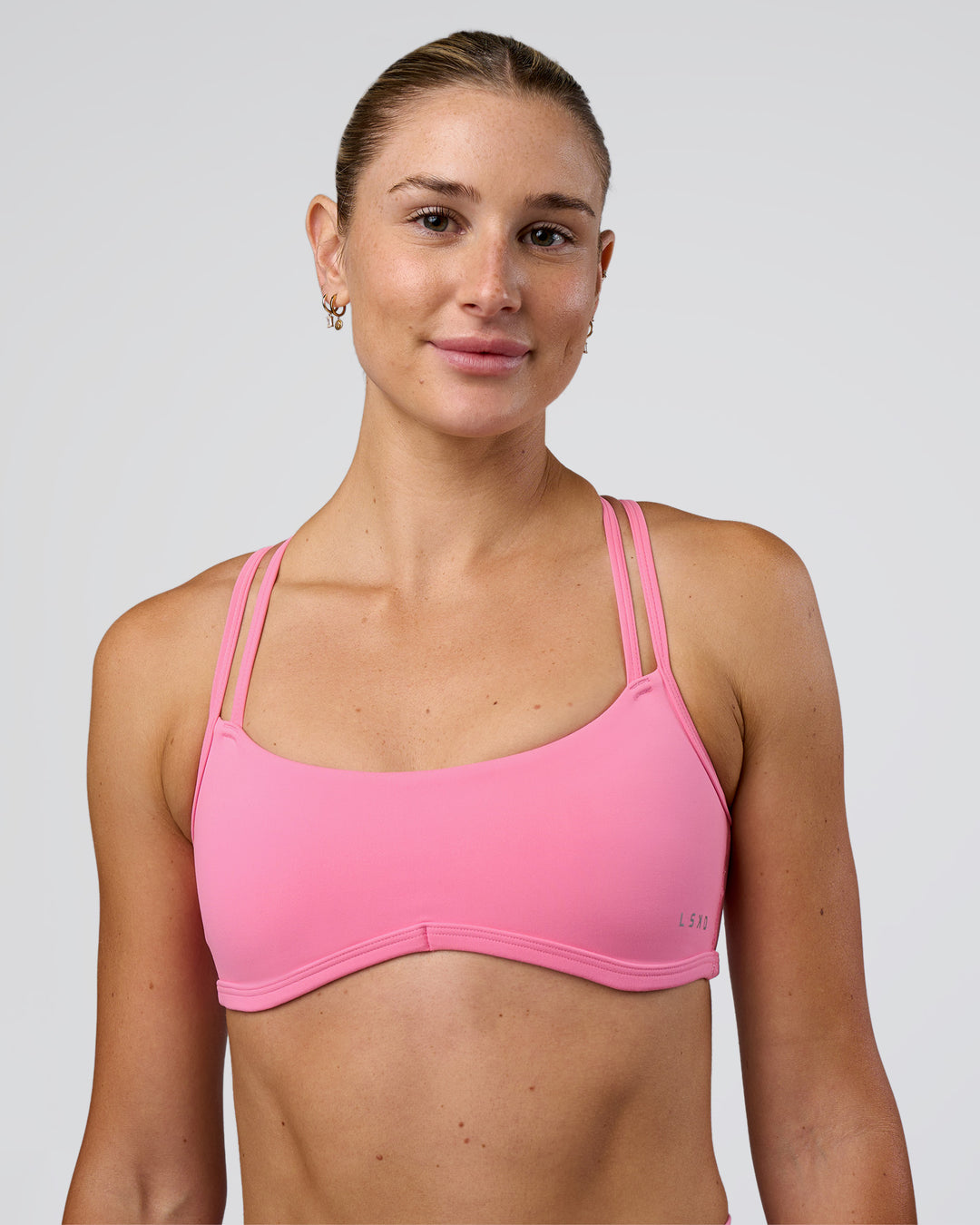 Woman wearing Interstellar Sports Bra - Candy Pink | Model:Emelia | Size:XS - view 1