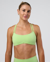 Woman wearing Interstellar Sports Bra - Solar Lime | Model:Emelia | Size:XS | Thumbnail Index: 2