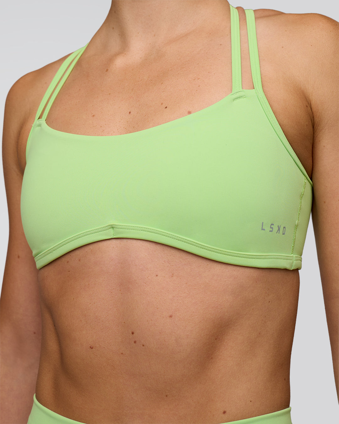 Woman wearing Interstellar Sports Bra - Solar Lime | Model:Emelia | Size:XS - view 6