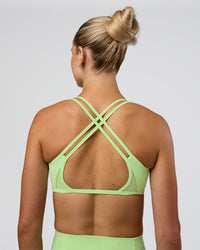 Woman wearing Interstellar Sports Bra - Solar Lime | Model:Emelia | Size:XS | Thumbnail Index: 1