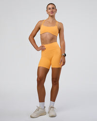 Woman wearing Interstellar Sports Bra - Warm Apricot | Model:Emelia | Size:XS | Thumbnail Index: 3