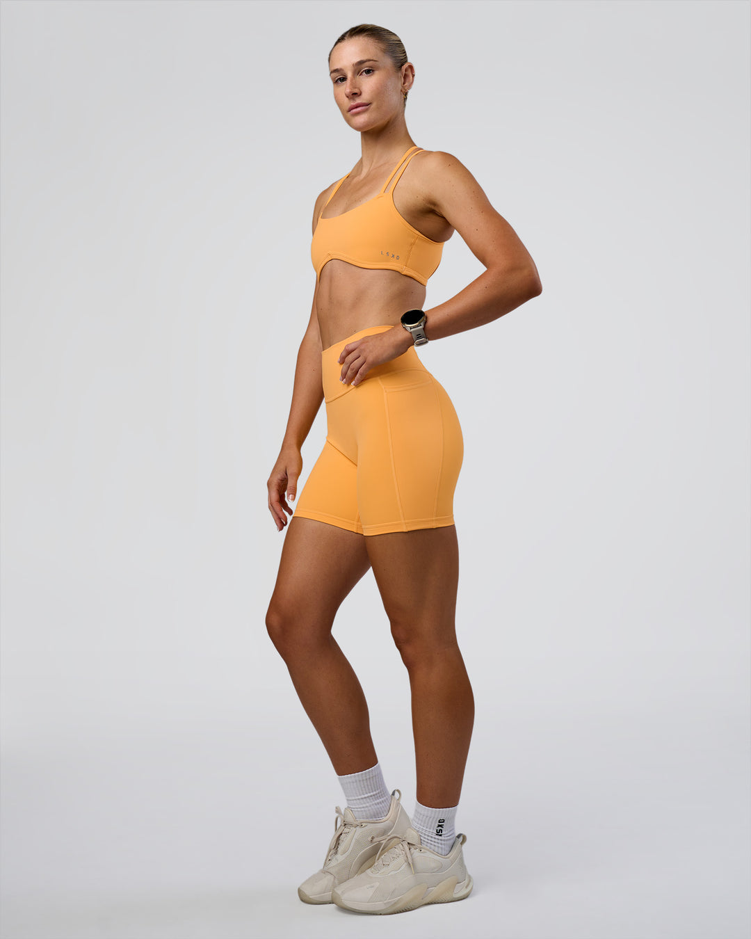 Woman wearing Interstellar Sports Bra - Warm Apricot | Model:Emelia | Size:XS - view 5