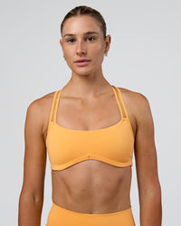 Woman wearing Interstellar Sports Bra - Warm Apricot | Model:Emelia | Size:XS | Thumbnail Index: 5