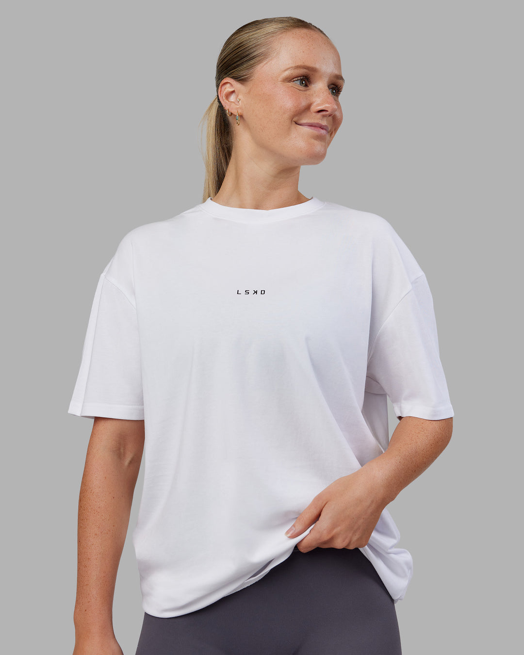 Woman wearing Kettlebell FLXCotton Oversized Tee - White-Black | Model:Neve | Size:XS - view 2
