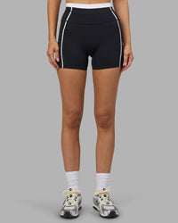 Woman wearing Liberate Contrast High-Rise 4" Short Pockets - Black-White | Model:Leilani | Size:XS | Thumbnail Index: 1
