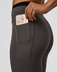 Woman wearing Liberate High-Rise Full Length Legging Pockets in Duskstone-Black | Model:Maja | Size:XS | Thumbnail Index: 1