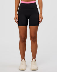 Woman wearing Liberate High-Rise 6" Short Pockets - Black-Candy Pink | Model:Brylee | Size:XS | Thumbnail Index: 4