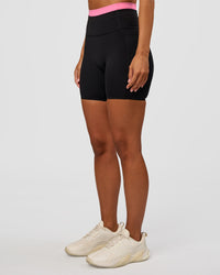 Woman wearing Liberate High-Rise 6" Short Pockets - Black-Candy Pink | Model:Brylee | Size:XS | Thumbnail Index: 5