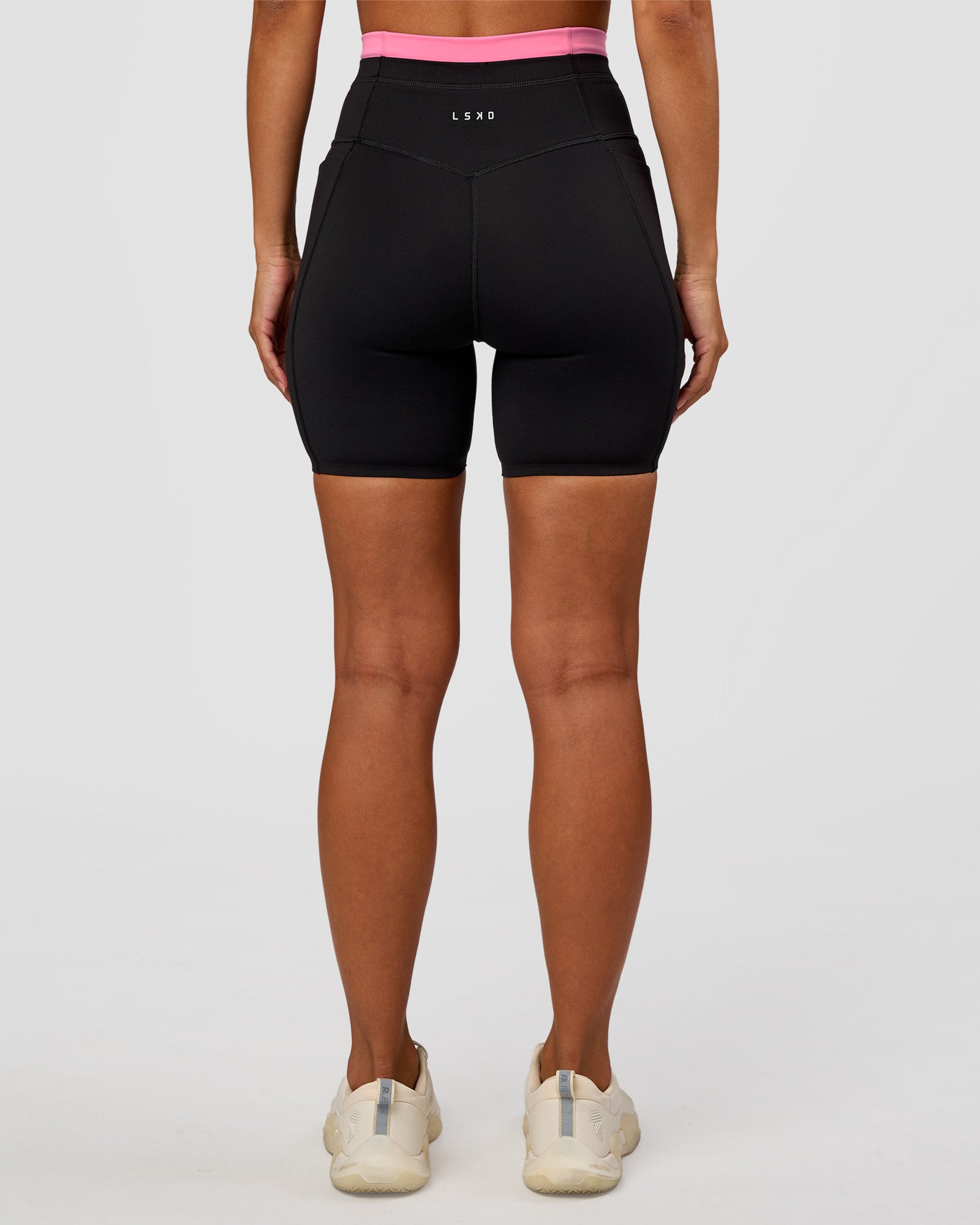 Woman wearing Liberate High-Rise 6" Short Pockets - Black-Candy Pink | Model:Brylee | Size:XS
