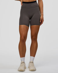 Woman wearing Liberate High-Rise 6" Short Pockets in Duskstone-Black | Model:Maja | Size:XS | Thumbnail Index: 0