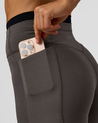 Woman wearing Liberate High-Rise 6" Short Pockets in Duskstone-Black | Model:Maja | Size:XS | Thumbnail Index: 1