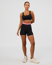 Woman wearing Liberate High-Rise 4" Short Pockets - Black-Candy Pink | Model:Brylee | Size:XS | Thumbnail Index: 2