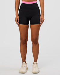 Woman wearing Liberate High-Rise 4" Short Pockets - Black-Candy Pink | Model:Brylee | Size:XS | Thumbnail Index: 3