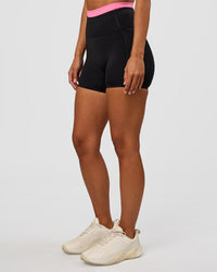 Woman wearing Liberate High-Rise 4" Short Pockets - Black-Candy Pink | Model:Brylee | Size:XS | Thumbnail Index: 4