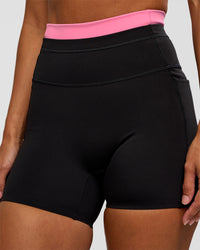Woman wearing Liberate High-Rise 4" Short Pockets - Black-Candy Pink | Model:Brylee | Size:XS | Thumbnail Index: 5