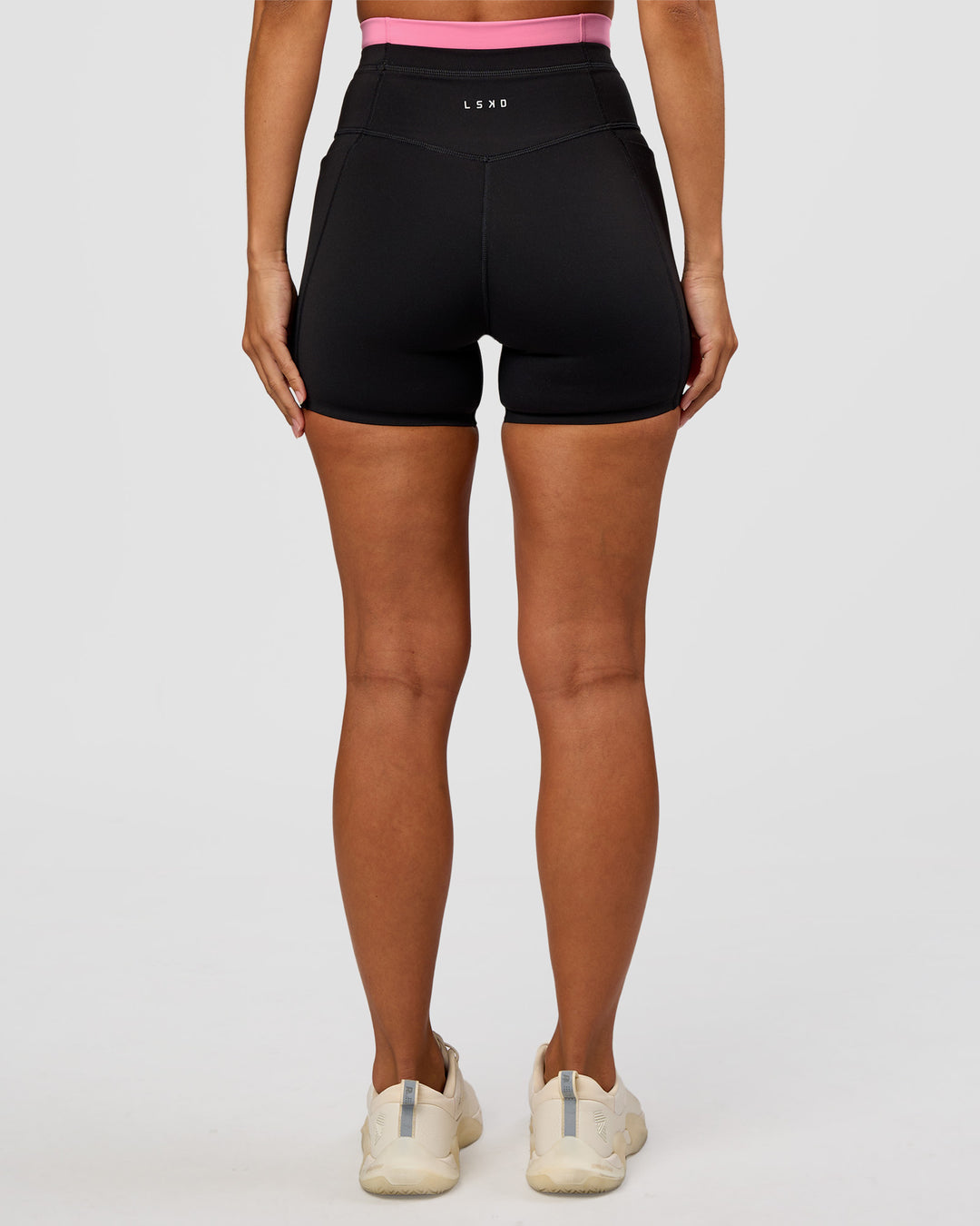 Woman wearing Liberate High-Rise 4" Short Pockets - Black-Candy Pink | Model:Brylee | Size:XS - view 7