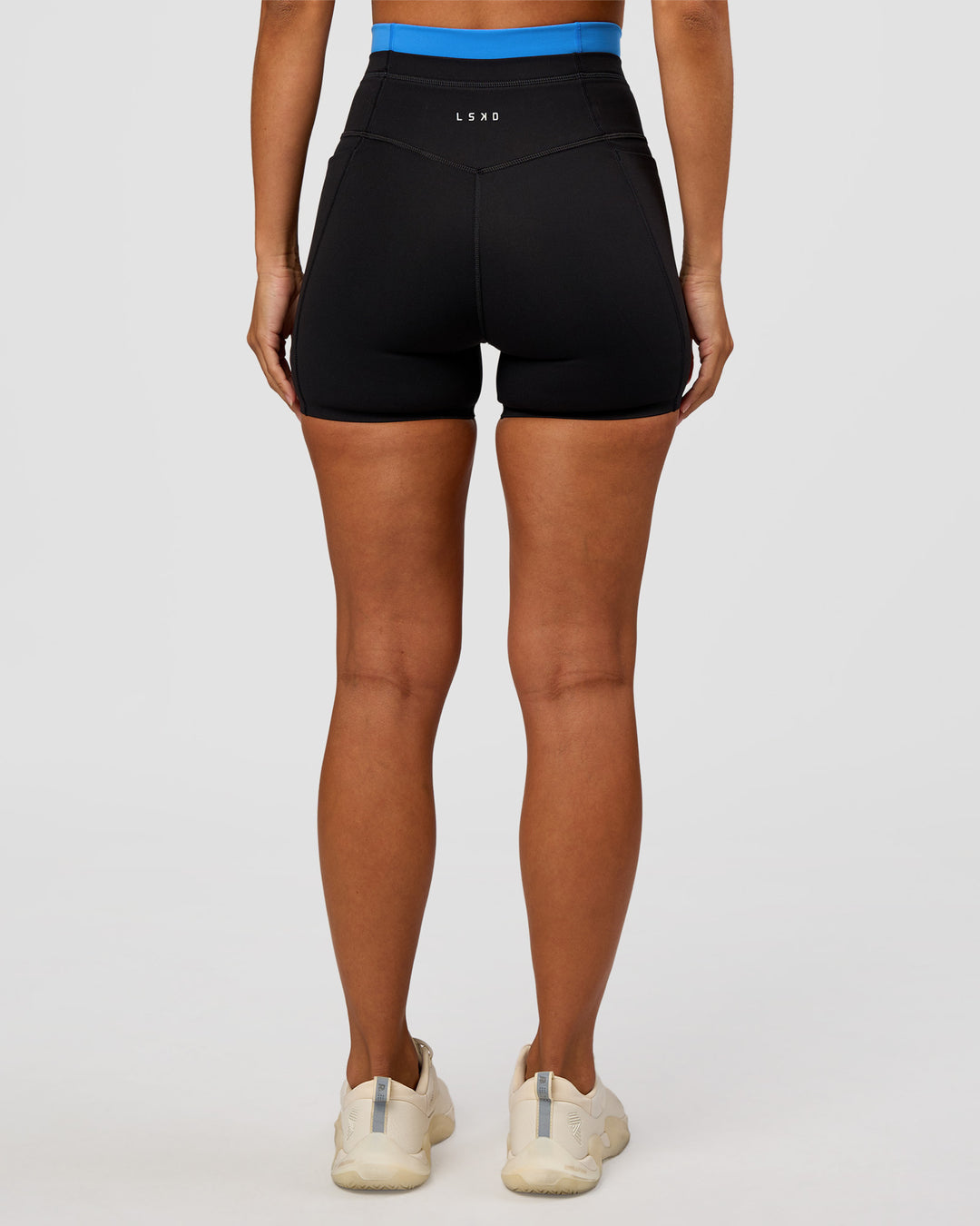 Woman wearing Liberate High-Rise 4" Short Pockets - Black-Palace Blue | Model:Brylee | Size:XS - view 7