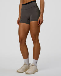 Woman wearing Liberate High-Rise 4" Short Pockets in Duskstone-Black | Model:Maja | Size:XS | Thumbnail Index: 6