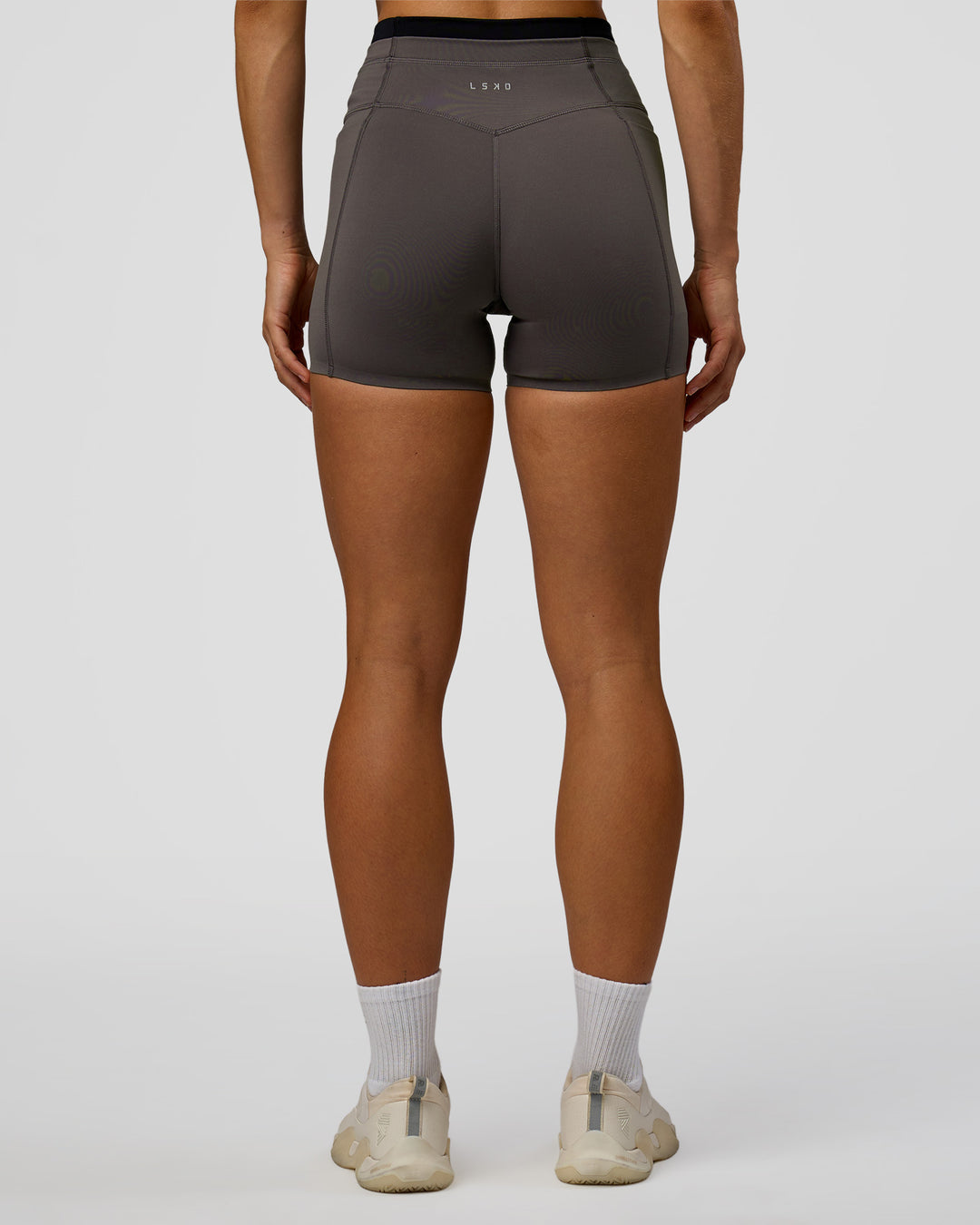 Woman wearing Liberate High-Rise 4" Short Pockets in Duskstone-Black | Model:Maja | Size:XS - view 3